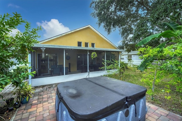 1122 Vinetree Dr, Brandon, FL 33510 - rear view of property with a hot tub, a sunroom, fence, and stucco siding