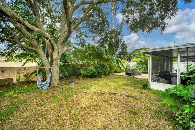 view of yard with a sunroom