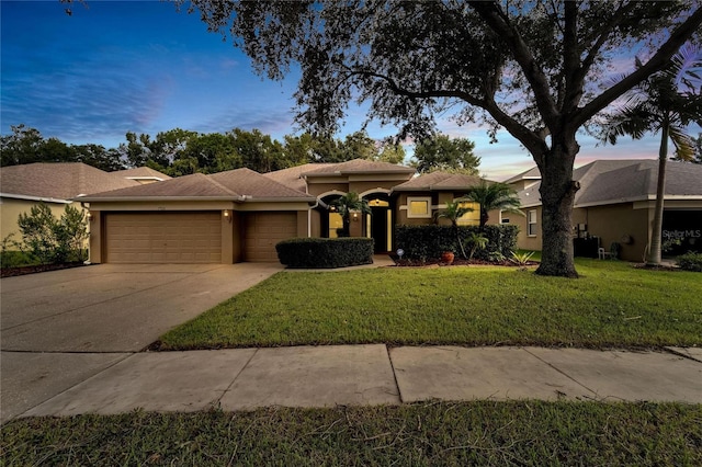 view of front of home featuring a yard and a garage