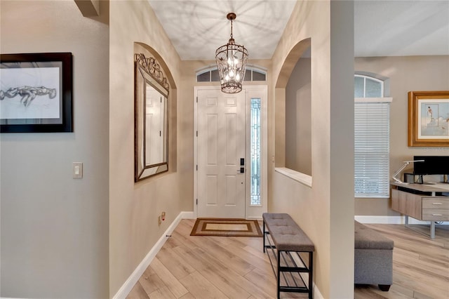 foyer entrance featuring light hardwood / wood-style flooring and a chandelier