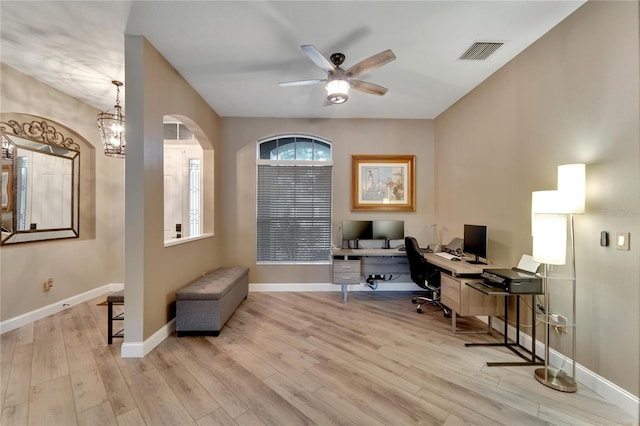 office featuring light wood-type flooring and ceiling fan with notable chandelier