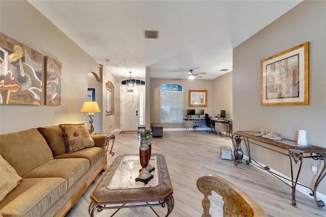 living room with light hardwood / wood-style flooring and ceiling fan