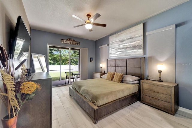 bedroom featuring ceiling fan, a textured ceiling, light wood-type flooring, and access to outside