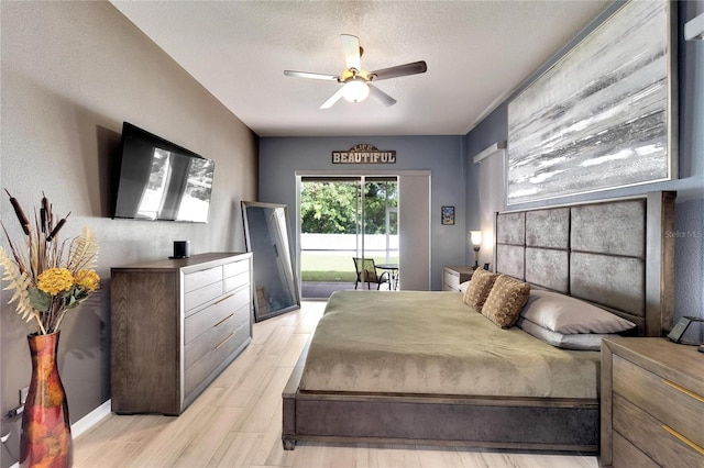 bedroom featuring ceiling fan, a textured ceiling, light wood-type flooring, and access to outside