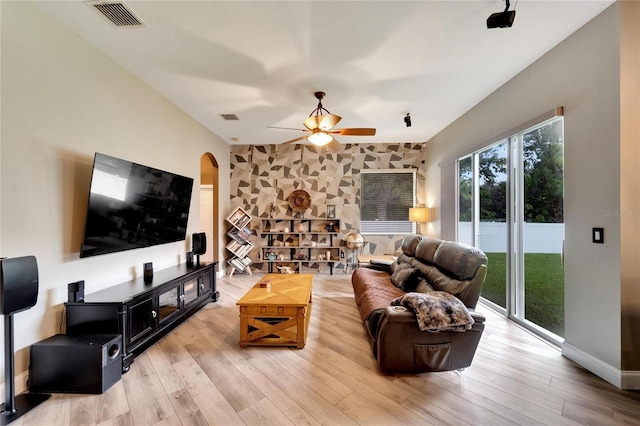 living room featuring ceiling fan and light hardwood / wood-style flooring