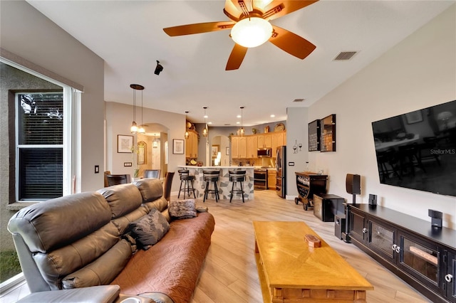 living room featuring light hardwood / wood-style floors and ceiling fan