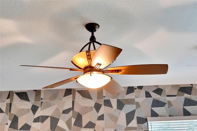 interior details featuring ceiling fan and a textured ceiling