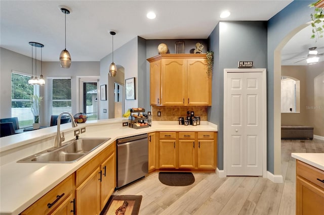 kitchen with light hardwood / wood-style floors, sink, decorative light fixtures, ceiling fan, and stainless steel dishwasher