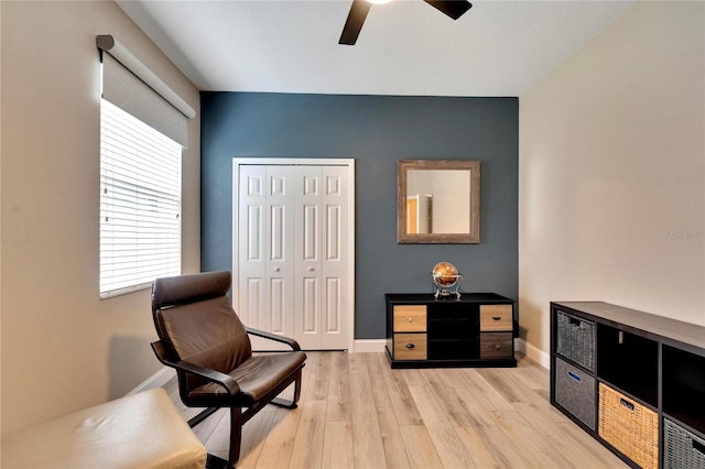 sitting room with ceiling fan and light hardwood / wood-style flooring