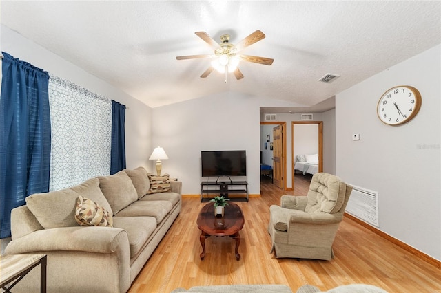 living room featuring a textured ceiling, vaulted ceiling, ceiling fan, and hardwood / wood-style flooring