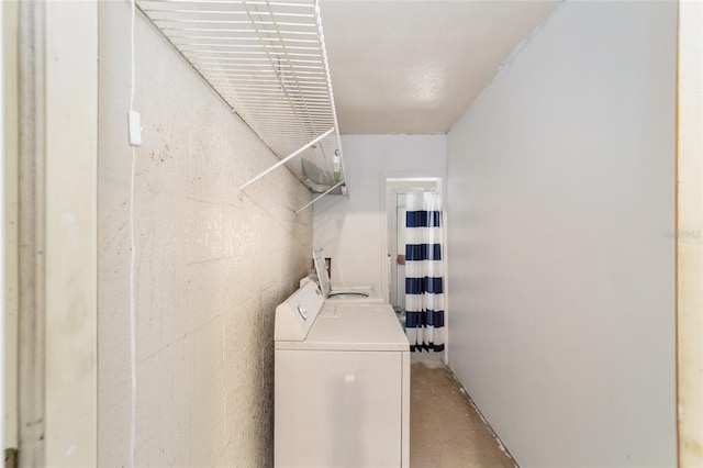 washroom with washing machine and clothes dryer