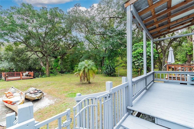 wooden deck featuring a yard