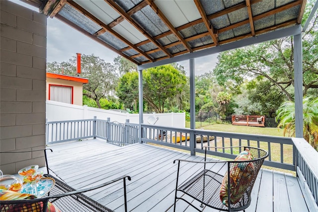 wooden deck featuring a lawn