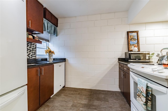 kitchen with tile walls, white appliances, and decorative backsplash