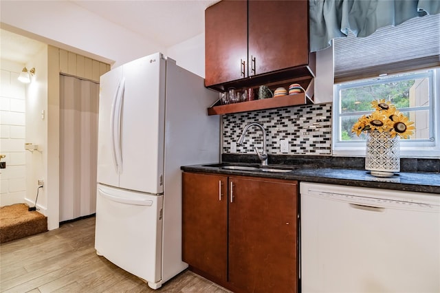 kitchen with light wood-type flooring, white appliances, sink, and tasteful backsplash