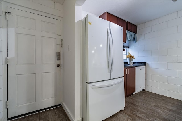 kitchen with white refrigerator and dark hardwood / wood-style floors