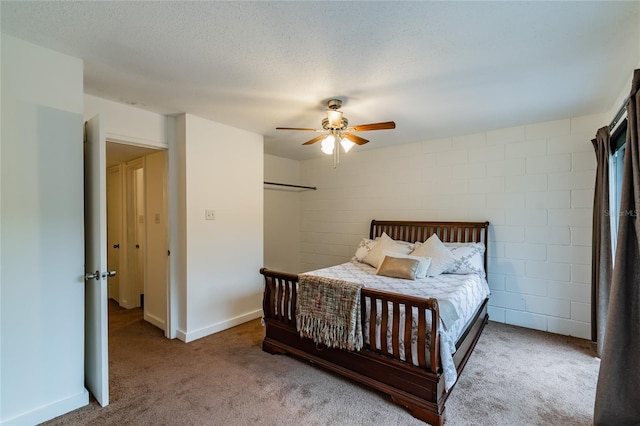 bedroom featuring a textured ceiling, ceiling fan, and carpet floors