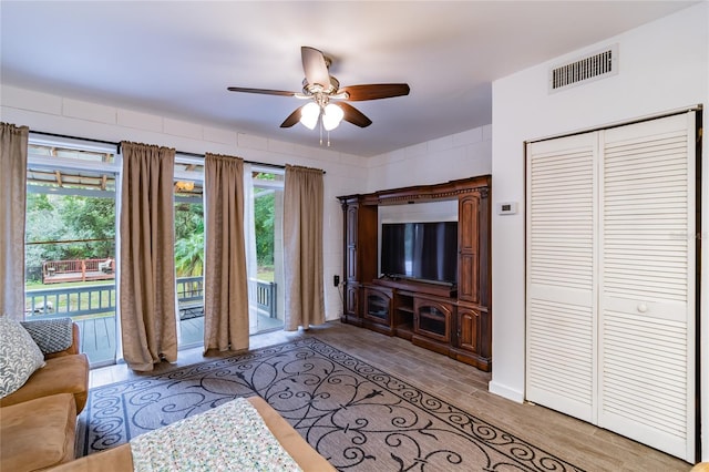 living room featuring ceiling fan and light wood-type flooring