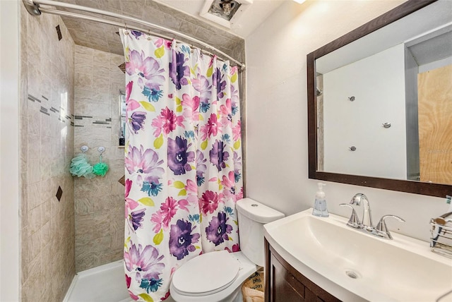 bathroom with vanity, toilet, and walk in shower