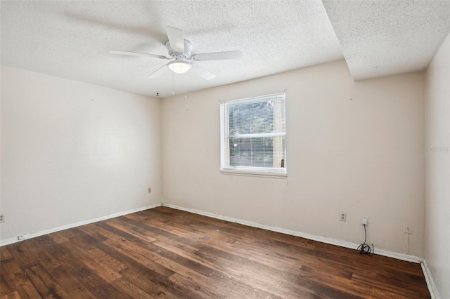 empty room featuring a textured ceiling, ceiling fan, and dark wood-type flooring