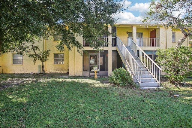 rear view of property with a yard