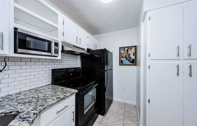 kitchen featuring white cabinets, decorative backsplash, black appliances, light tile patterned floors, and light stone countertops