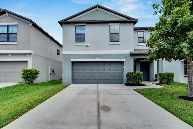 view of front of home featuring a front lawn and a garage