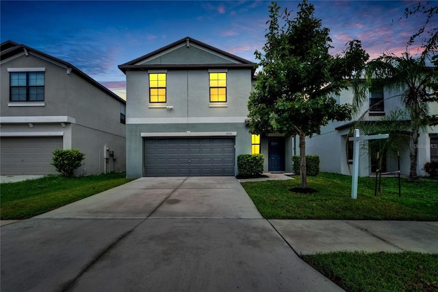 view of front property featuring a yard and a garage