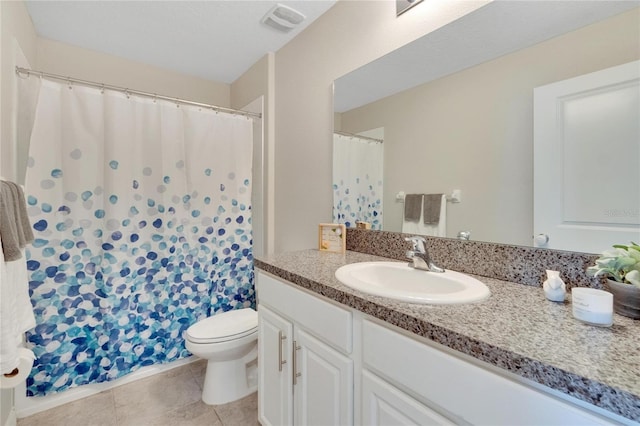 bathroom featuring tile patterned floors, vanity, and toilet