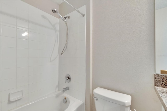 full bathroom featuring vanity, tiled shower / bath combo, and toilet