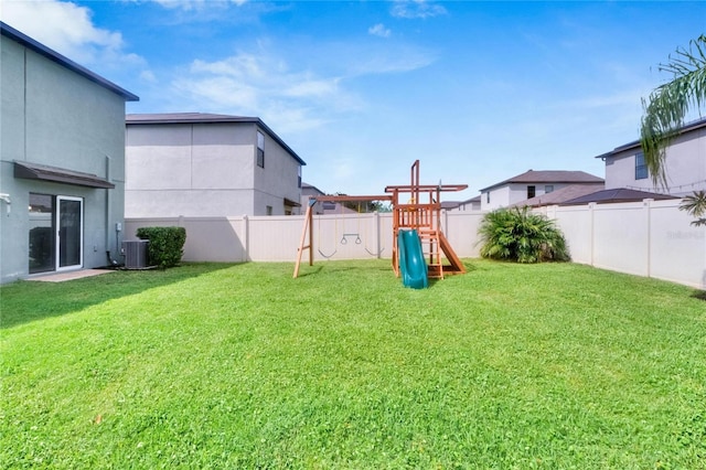 view of yard with a playground and central AC unit