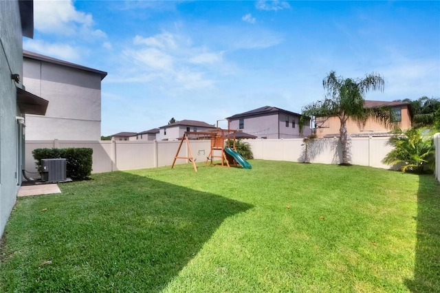 view of yard featuring central AC unit and a playground