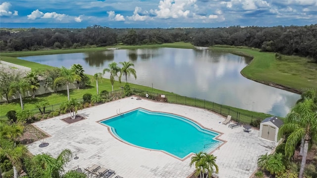 view of swimming pool with a water view and a patio