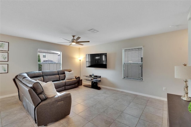 living room featuring ceiling fan and light tile patterned flooring