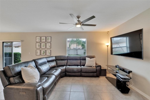 tiled living room with ceiling fan and a healthy amount of sunlight