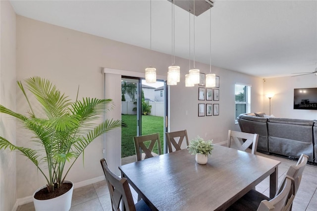 tiled dining area featuring ceiling fan