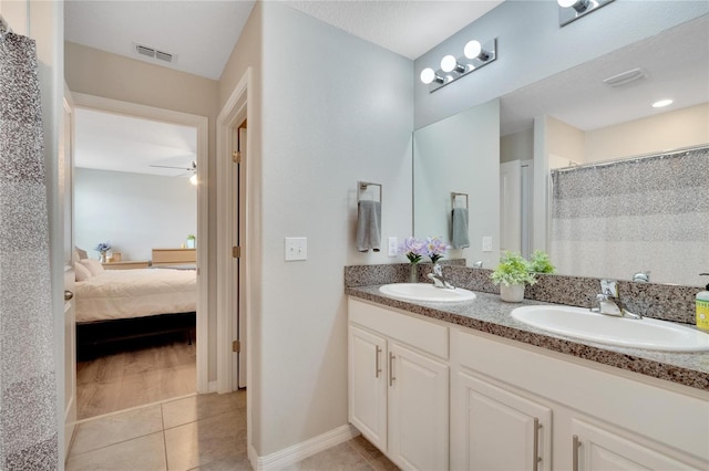 bathroom featuring a shower with shower curtain, vanity, tile patterned floors, and ceiling fan