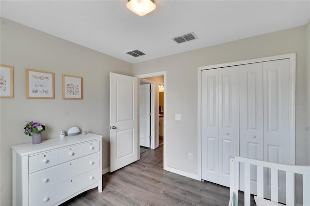 bedroom featuring light wood-type flooring and a closet