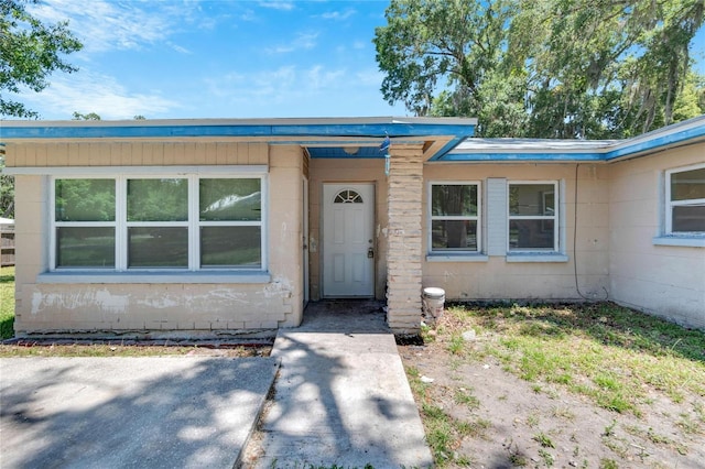 view of front of property with concrete block siding