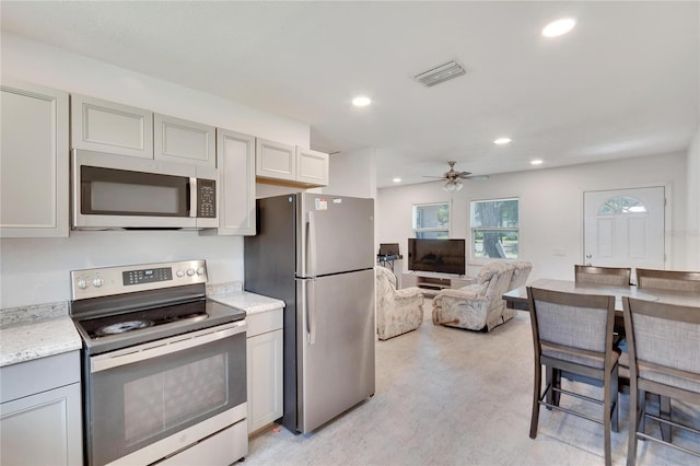 kitchen with gray cabinets, a ceiling fan, stainless steel appliances, visible vents, and recessed lighting