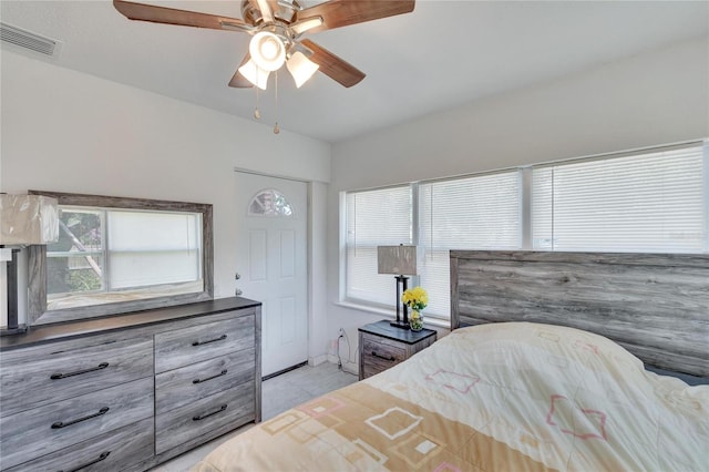 bedroom featuring ceiling fan and multiple windows