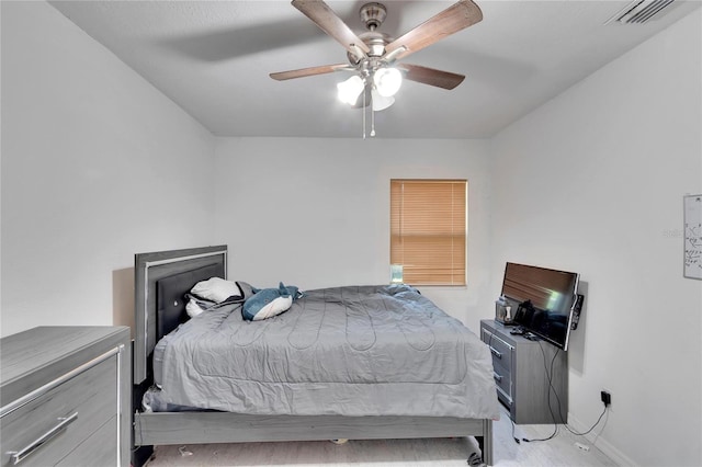 bedroom featuring baseboards, ceiling fan, and visible vents