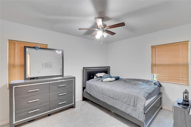 bedroom with baseboards and a ceiling fan