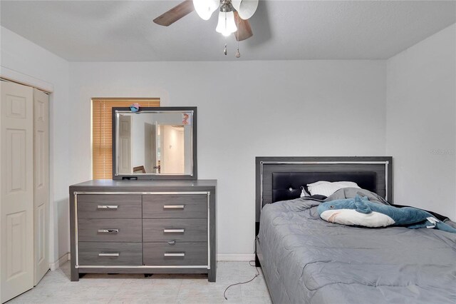 bedroom with baseboards, a closet, and ceiling fan