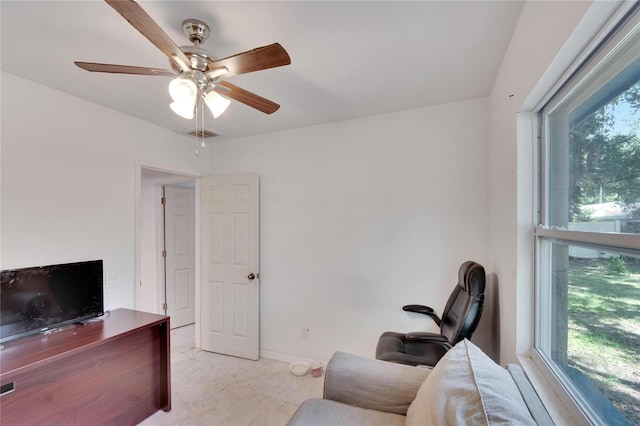 interior space with baseboards, visible vents, ceiling fan, and a healthy amount of sunlight
