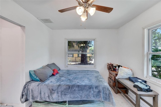 bedroom with a ceiling fan and visible vents