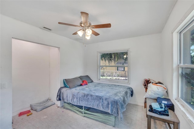 bedroom with baseboards, ceiling fan, and visible vents