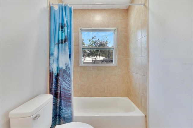 bathroom with shower / bath combo and toilet