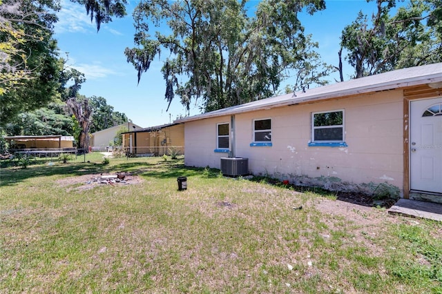 view of yard with fence and central AC