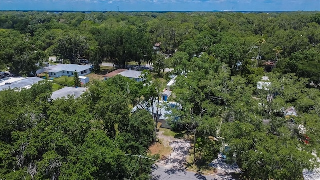 birds eye view of property featuring a forest view